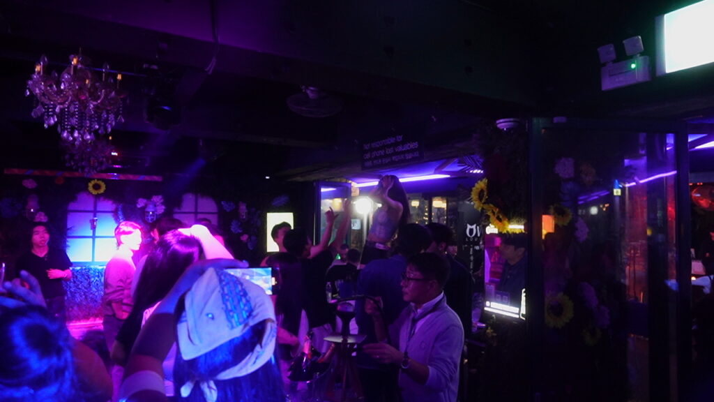 Crowded dance floor at a popular Itaewon nightclub in Seoul, featuring vibrant lights and a lively atmosphere