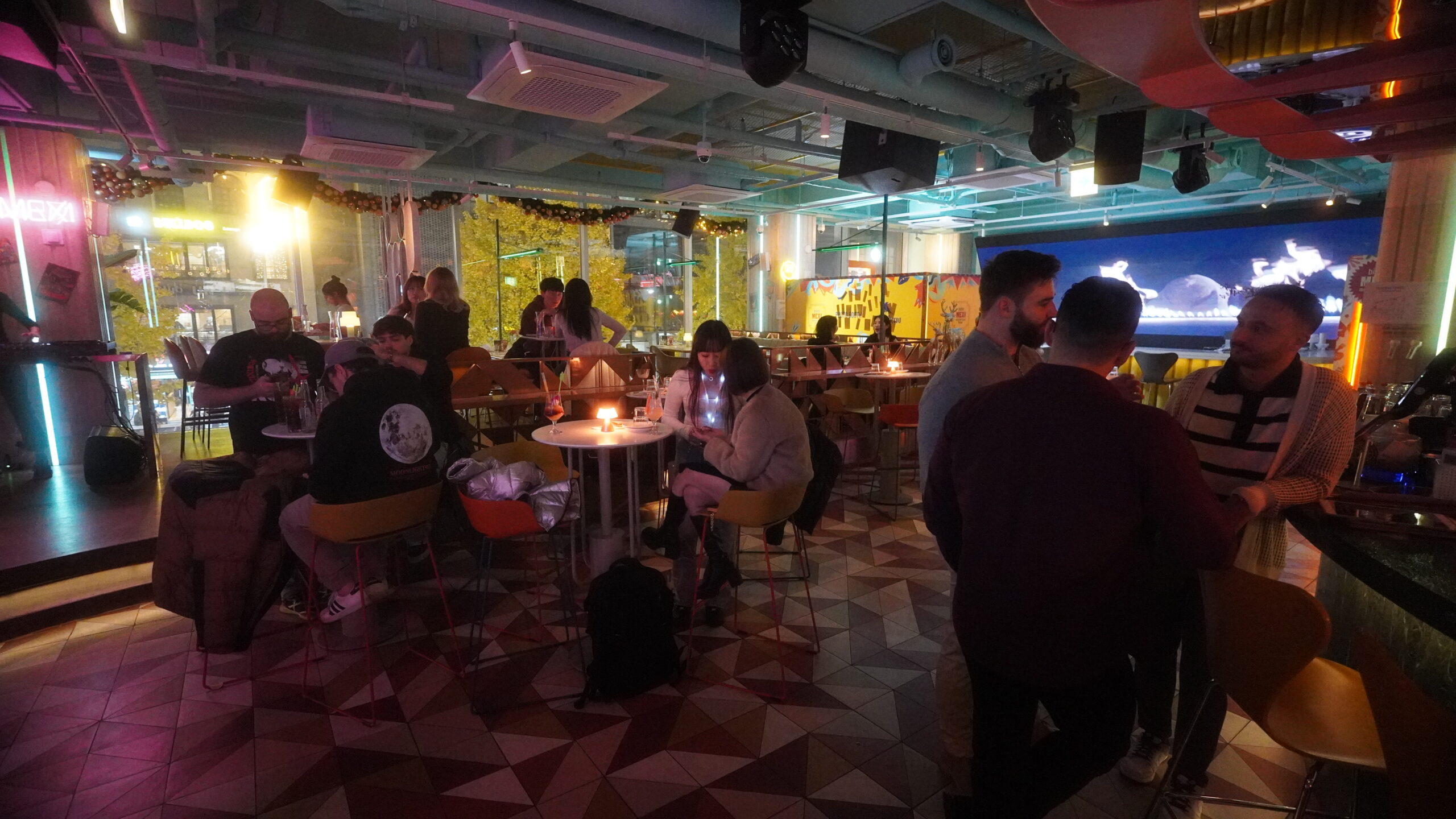 Lively interior of Bistro Mexi in Itaewon, bustling with a crowd enjoying drinks, dancing, and the vibrant atmosphere of the venue.