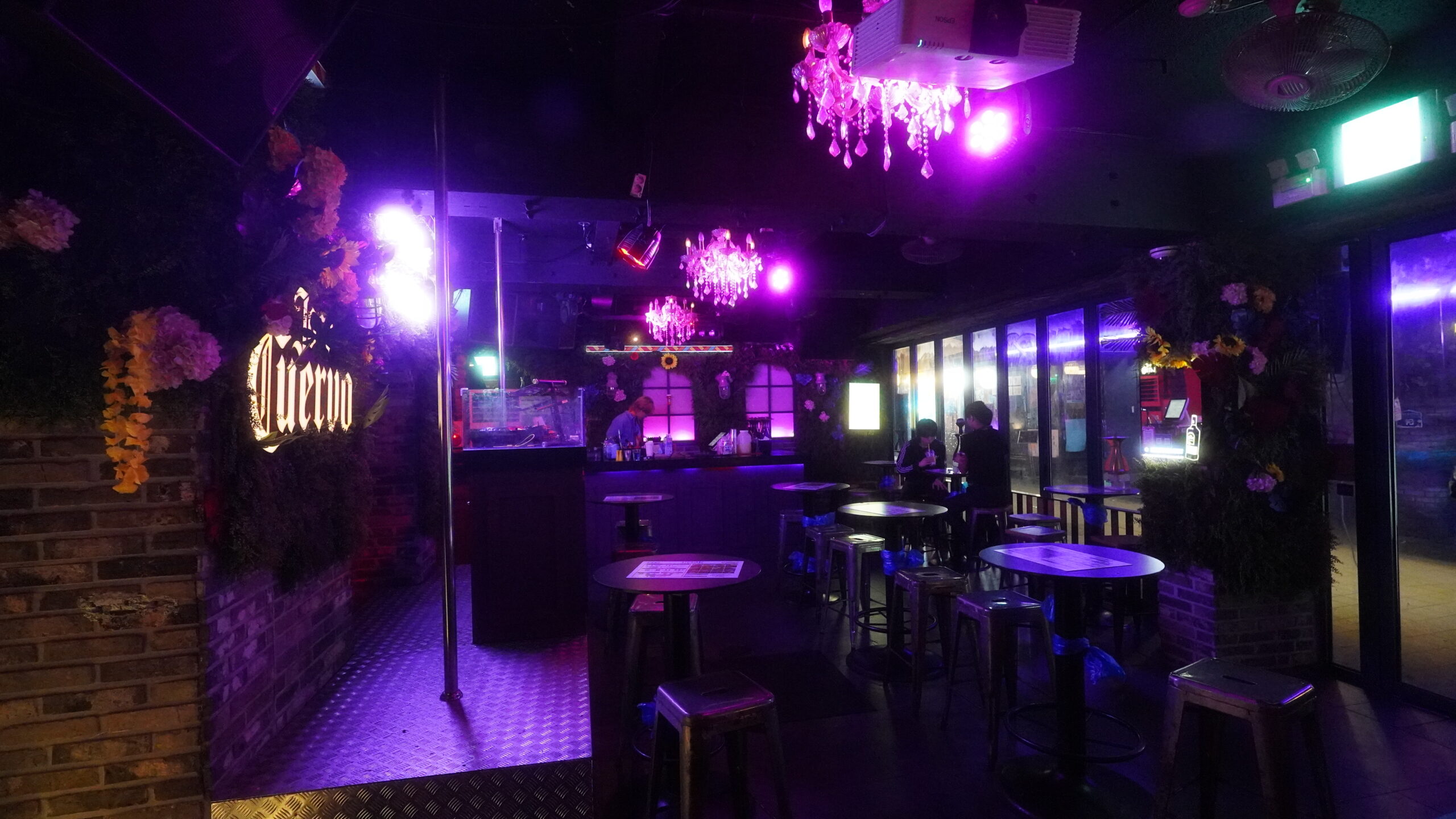 Interior of a high-energy Itaewon nightclub with strobe lights.